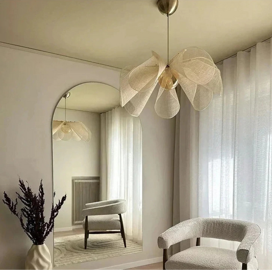 Modern interior with a decorative ceiling light fixture, chair, and mirror.