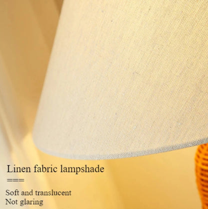 Close-up of a linen fabric lampshade with text describing its properties.